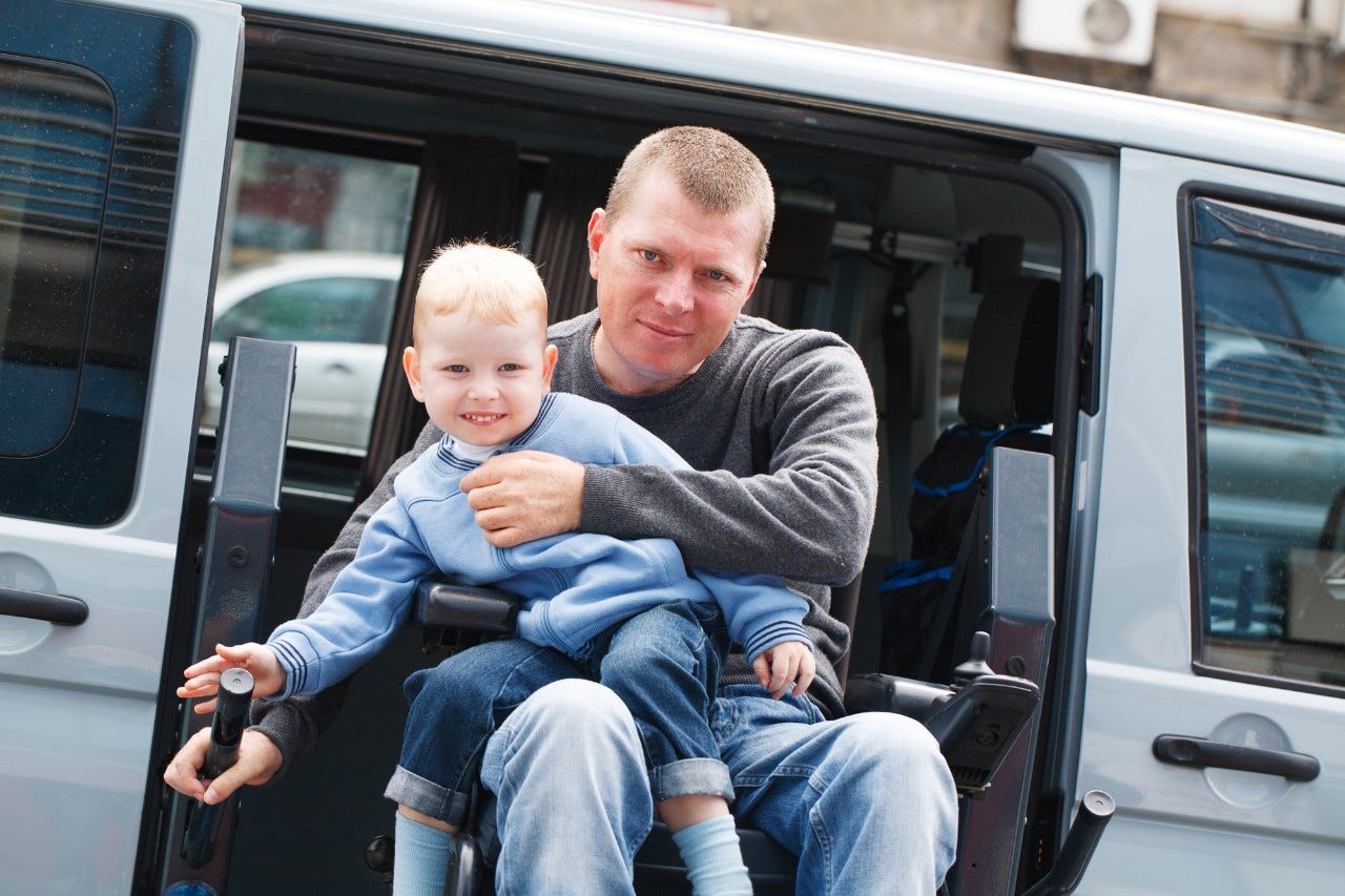 4 year old boy and 35 year old Disabled Men on Wheelchair Lift