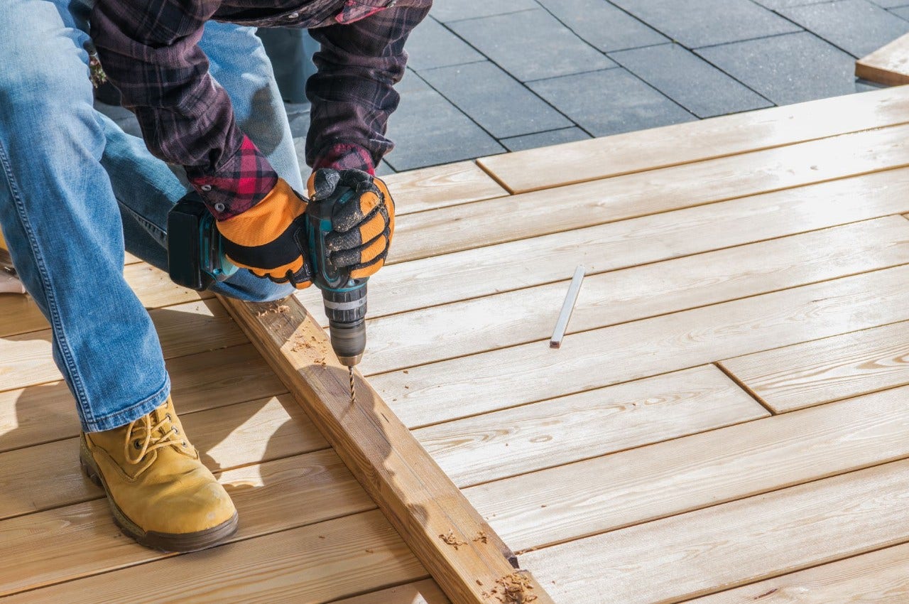 Person bulding on wooden deck