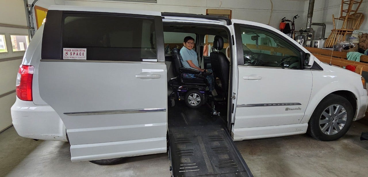 woman in wheelchair inside accessible braunability dodge van