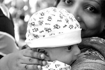 B/W Woman holding newborn son